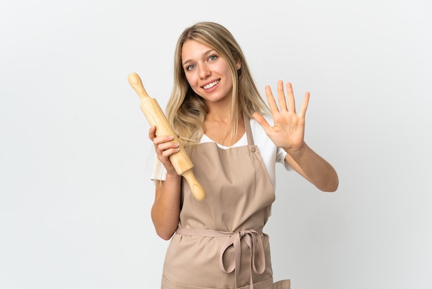 Jonge bakkerijvrouw die op wit wordt geïsoleerd