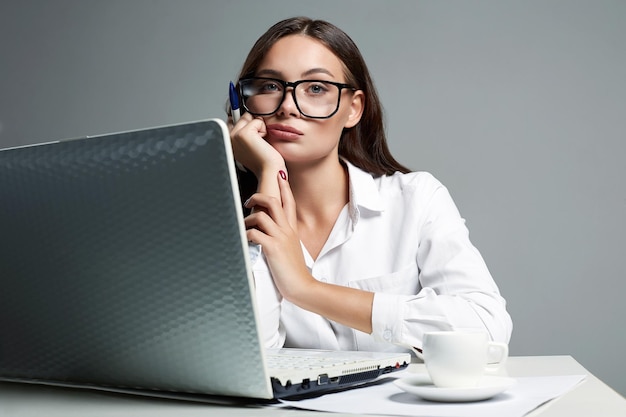 Jonge bedrijfsvrouw in het meisje van de bureaustudent met computer