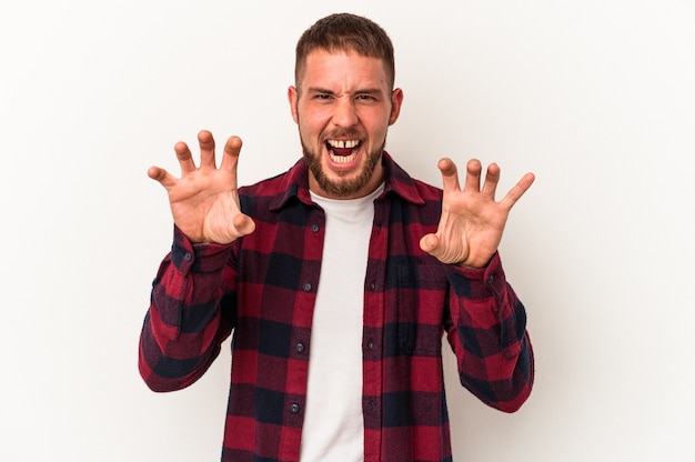 Jonge blanke man met diastema geïsoleerd op een witte achtergrond met klauwen die een kat imiteren, agressief gebaar.