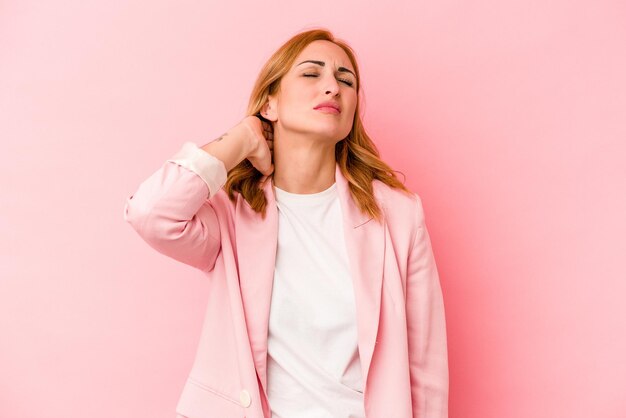 Jonge blanke vrouw geïsoleerd op roze achtergrond masseren elleboog, lijden na een slechte beweging.