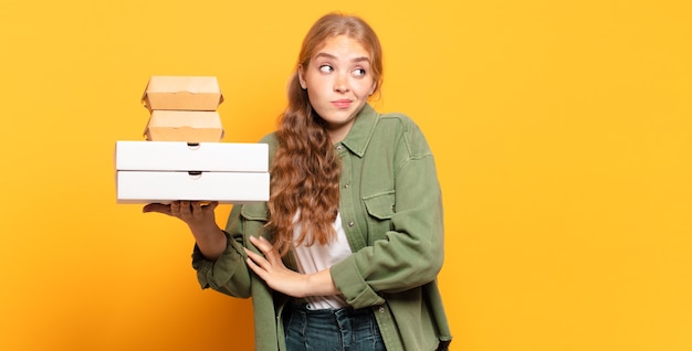 Jonge blonde vrouw die snel voedsel wegneemt