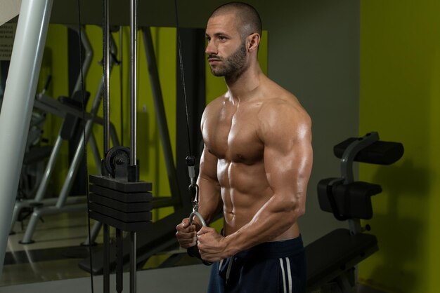 Jonge bodybuilder doet zware oefening voor triceps