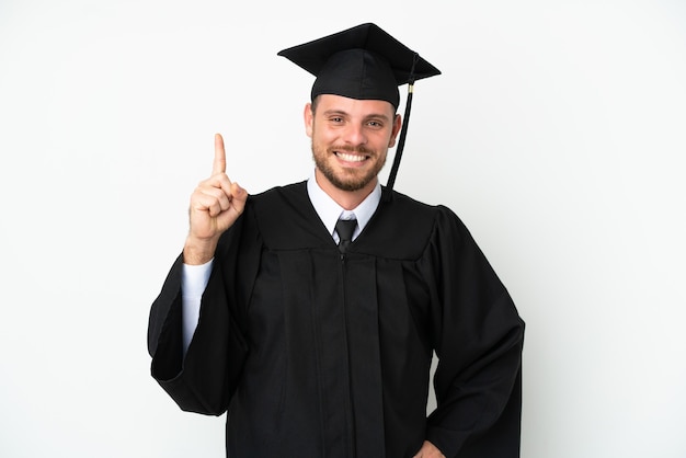 Jonge Braziliaanse afgestudeerde universiteit geïsoleerd op een witte achtergrond die een vinger toont en optilt in teken van de beste