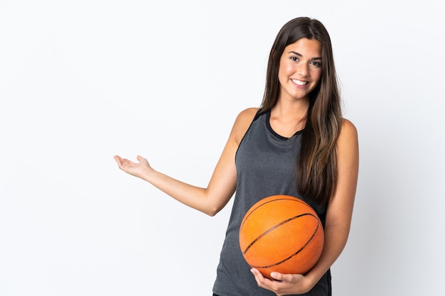 Jonge Braziliaanse vrouw basketbal spelen geïsoleerd op een witte achtergrond handen uitbreiden naar de zijkant voor uitnodigend om te komen