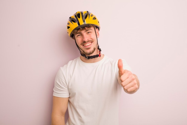 Jonge coole man die trots positief glimlacht met een duim omhoog fietsconcept