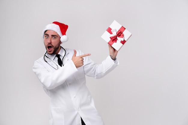 Jonge dokter in wit uniform en kerstman hoed