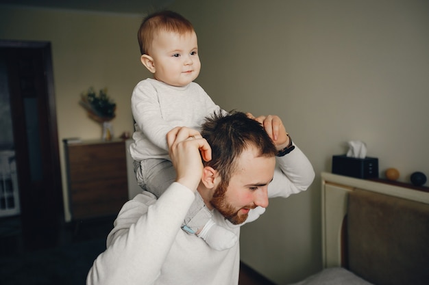 jonge en knappe vader spelen met zijn zoon thuis