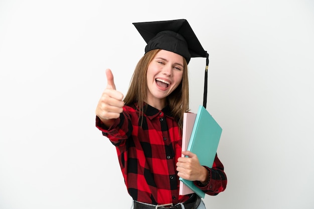 Jonge Engelse student vrouw geïsoleerd op een witte achtergrond met duimen omhoog omdat er iets goeds is gebeurd