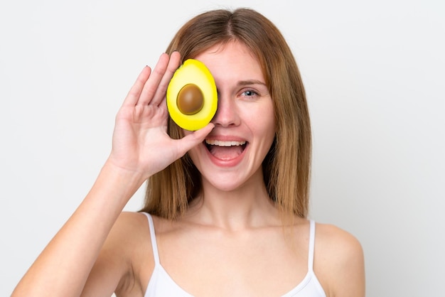 Jonge Engelse vrouw die een avocado vasthoudt terwijl ze lacht Close-up portret