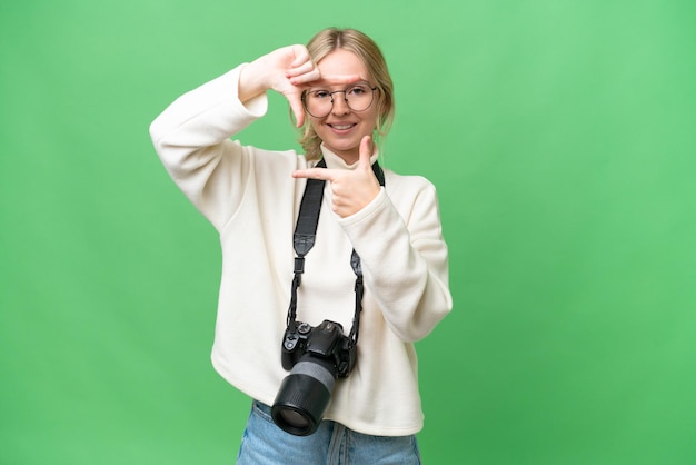 Jonge fotograaf Engelse vrouw over geïsoleerde achtergrond scherpstellen gezicht Framing symbool