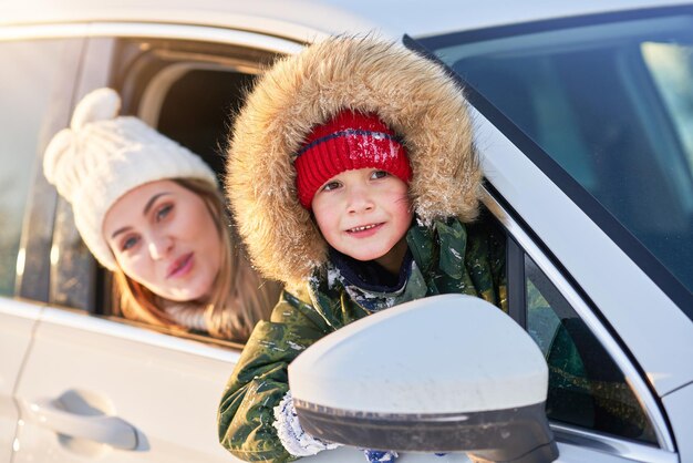 Jonge gelukkige jongen in de auto tijdens de winter. Hoge kwaliteit foto