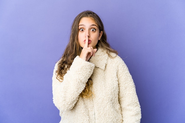 Jonge kaukasische leuke vrouw die een geheim houdt of om stilte vraagt.