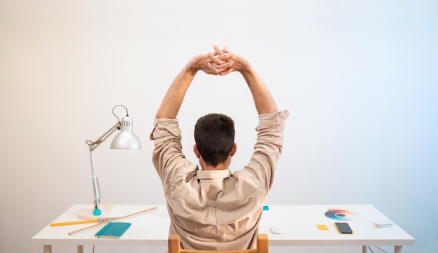 Jonge knappe man aan het werk vanuit huis op desktopcomputer Creatieve ontwerper ontspannen in zijn werkset