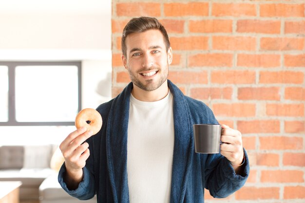 Jonge knappe man met een kopje koffie thuis