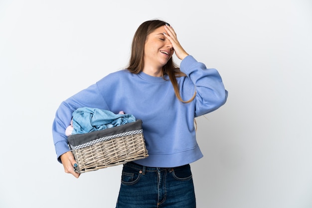 Jonge Litouwse vrouw die een wasmand houdt die op witte achtergrond wordt geïsoleerd die veel glimlacht