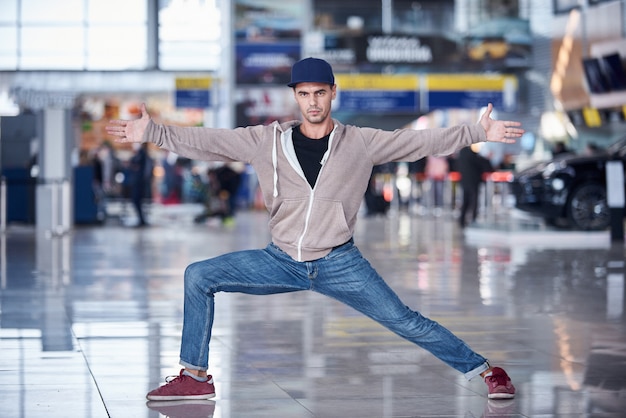 Jonge man beoefent yoga asana binnenshuis in de openbare ruimte