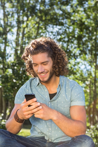 Jonge man met behulp van smartphone in het park