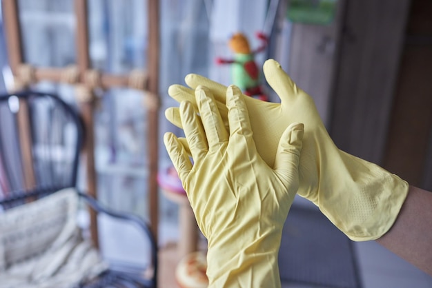 Jonge man met gele rubberen handschoenen Klaar om schoon te maken