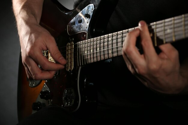 Jonge man spelen op elektrische gitaar close-up