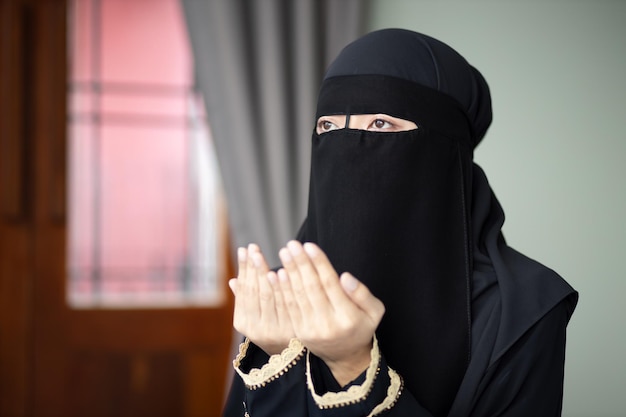 Jonge moderne Midden-Oosterse moslimvrouw met islamitisch gebed hand concept van Ramadan Eid al Fitr meditatie islamitische bidden islam festival moslim religieuze activiteiten