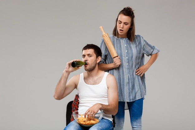 Jonge mooie vrouw boos op man bier drinken voetbal kijken