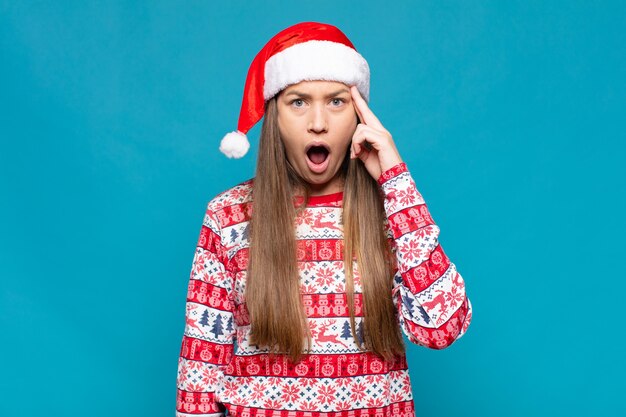 Jonge mooie vrouw die Kerstmiskleren draagt