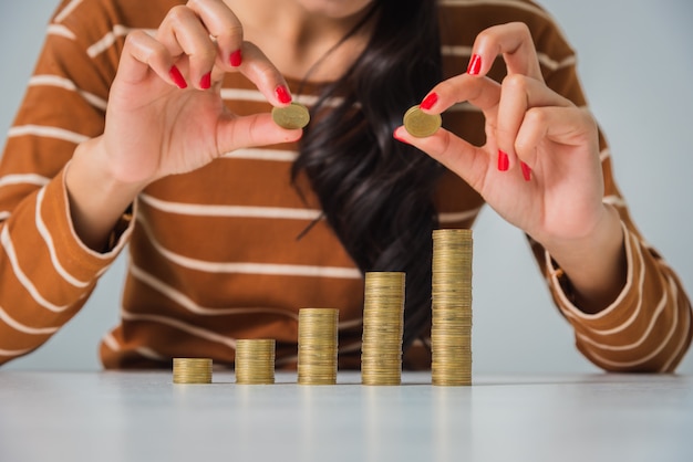 Jonge mooie vrouw met stapel munten