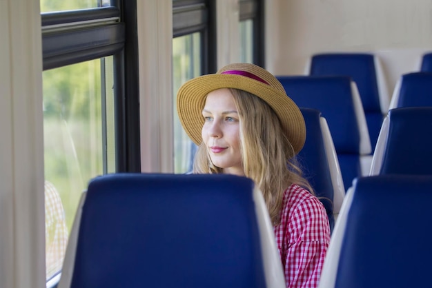 Jonge mooie vrouw zit bij het raam in de snelheidstrein