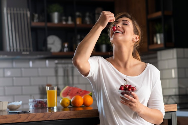 Jonge mooie vrouwen die kersen eten