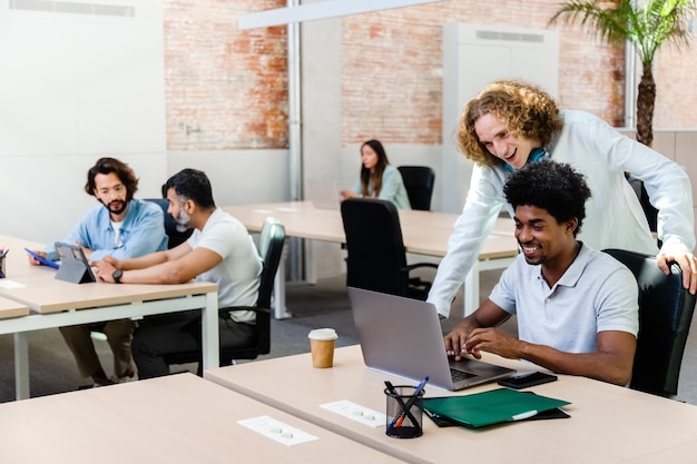 jonge multiraciale collega's werken op kantoor met laptop en tabletKopieer ruimte Coworking office