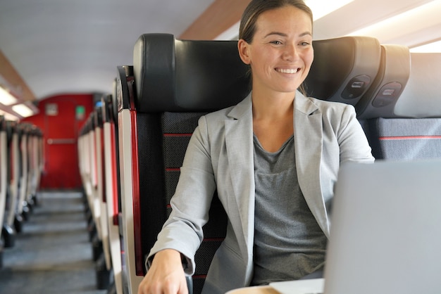 Jonge onderneemster die in eerste klasse aan een trein werkt