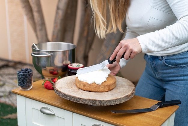 Jonge patissier die een zoete cake in de keuken kookt