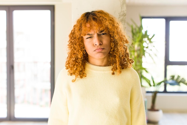 Foto jonge rode haar latijnse mooie vrouw in nieuw cool huis