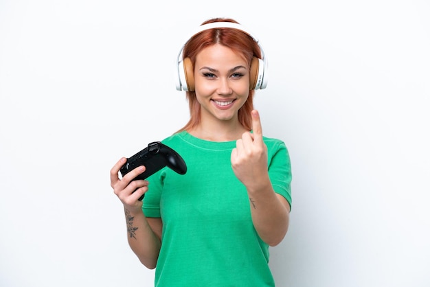 Jonge Russische meisje spelen met een video game controller geïsoleerd op een witte achtergrond doen komende gebaar