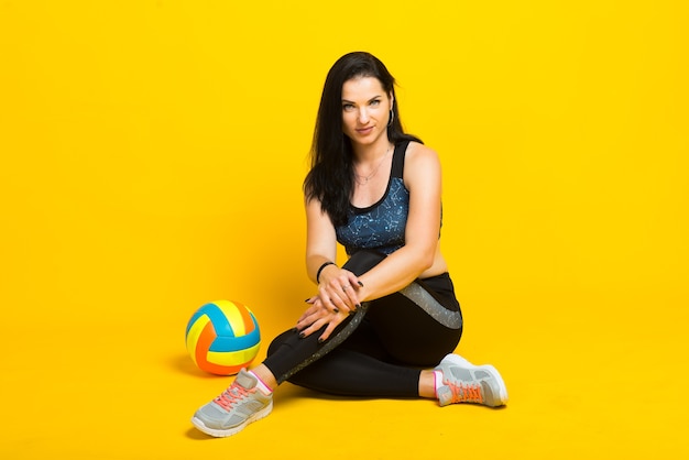 Jonge sportieve vrouw met een volleybal