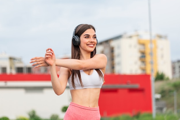 Jonge sportieve vrouw opleiding. Fit meisje streaching voor actieve fitnesstraining