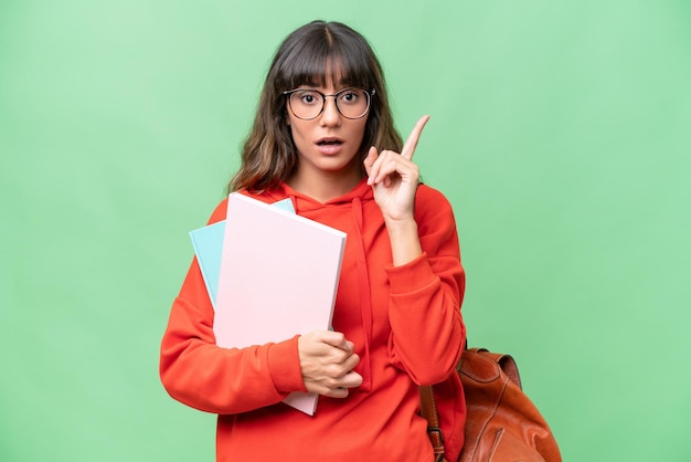 Jonge student blanke vrouw over geïsoleerde achtergrond die van plan is de oplossing te realiseren terwijl ze een vinger opsteekt