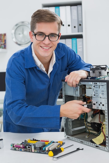 Jonge technicus die aan gebroken computer werkt