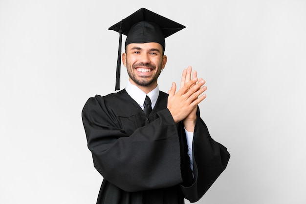 Jonge universitair afgestudeerde man over geïsoleerde witte achtergrond applaudisseren na presentatie op een conferentie