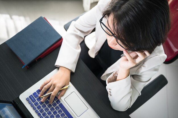 Jonge vrouw die aan laptop werkt