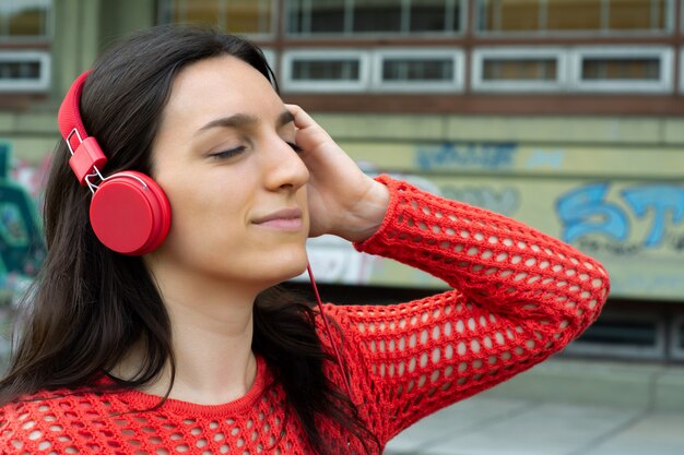 Jonge vrouw die aan muziek luistert