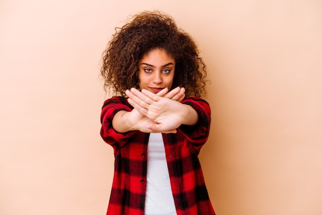 Foto jonge vrouw die op beige muur wordt geïsoleerd die een ontkenningsgebaar doet