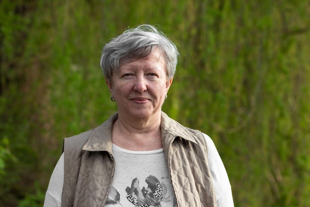 Foto jonge vrouw die tegen bomen staat.