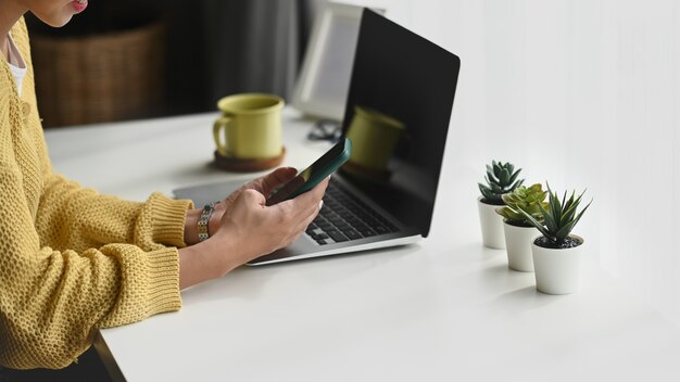 Jonge vrouw die thuis aan laptop werkt