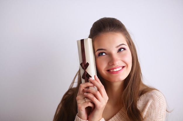 Jonge vrouw gelukkige glimlach houdt geschenkdoos in handen