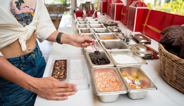 Jonge vrouw in de werkplaats tijdens een les over het maken van handgemaakte chocolade en snoep