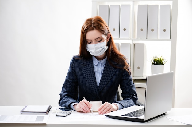 Jonge vrouw in een beschermend masker aan de balie