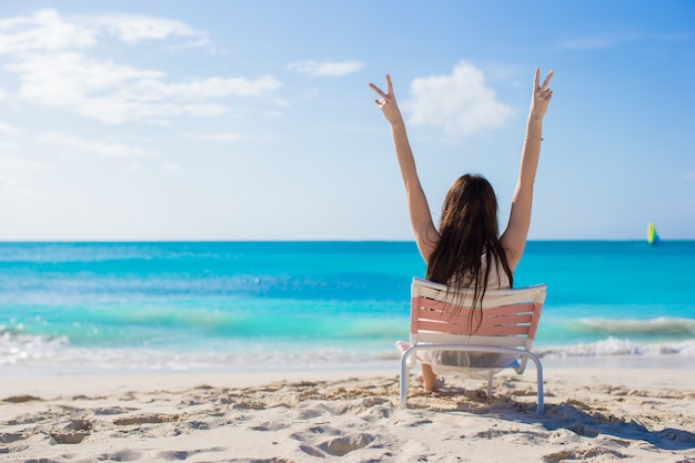 Jonge vrouw in strandstoel tijdens haar zomervakantie