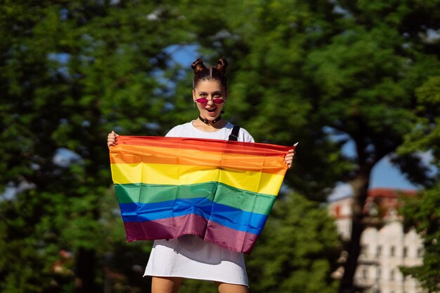 Jonge vrouw met een LGBT-trotsvlag in haar handen