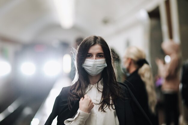 jonge vrouw met een medisch masker in de metro